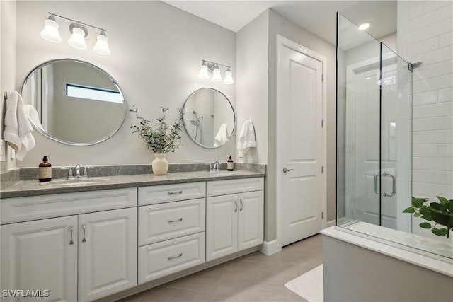 bathroom with vanity, a shower with shower door, and tile patterned floors