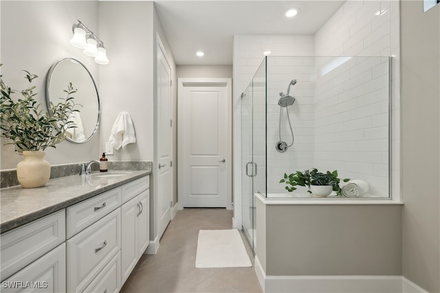 bathroom featuring a shower with door, tile patterned floors, and vanity