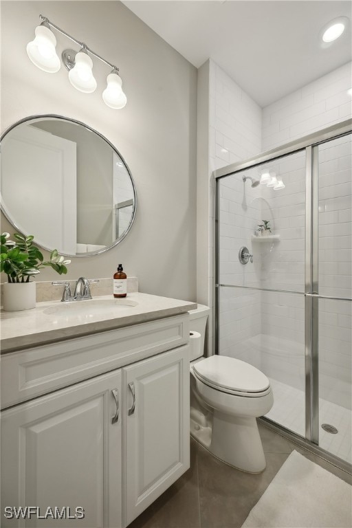 bathroom with walk in shower, tile patterned floors, vanity, and toilet