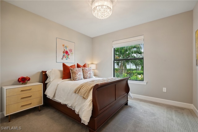 carpeted bedroom with an inviting chandelier