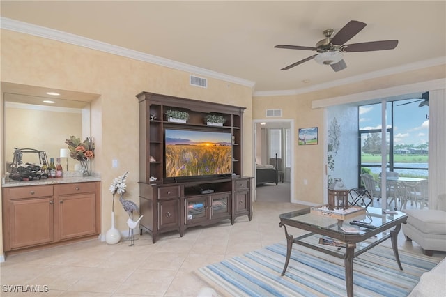 tiled living room with crown molding and ceiling fan