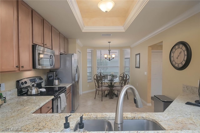 10296 Heritage Bay Blvd Unit 3111, Naples, FL 34120 - kitchen with light tile patterned floors, brown cabinets, a raised ceiling, stainless steel appliances, and an inviting chandelier