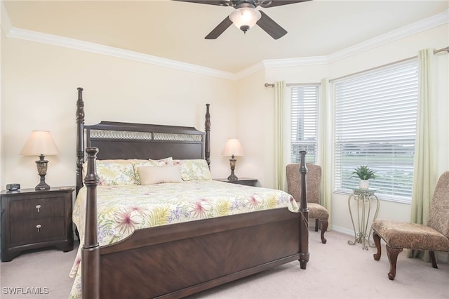 carpeted bedroom with ornamental molding and ceiling fan