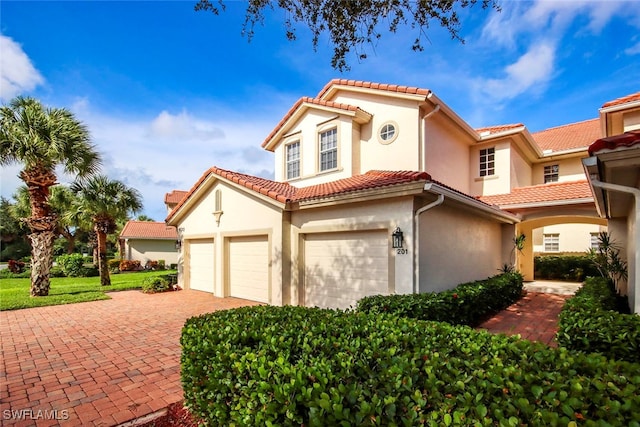 mediterranean / spanish-style house featuring a garage