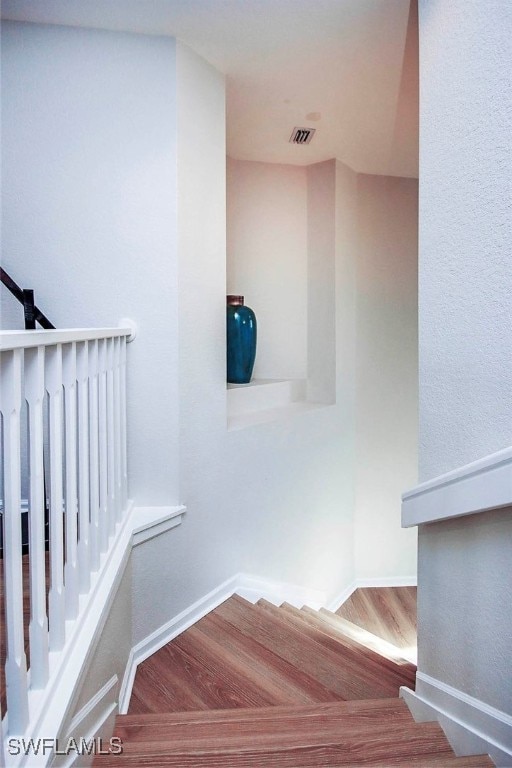 staircase featuring hardwood / wood-style floors