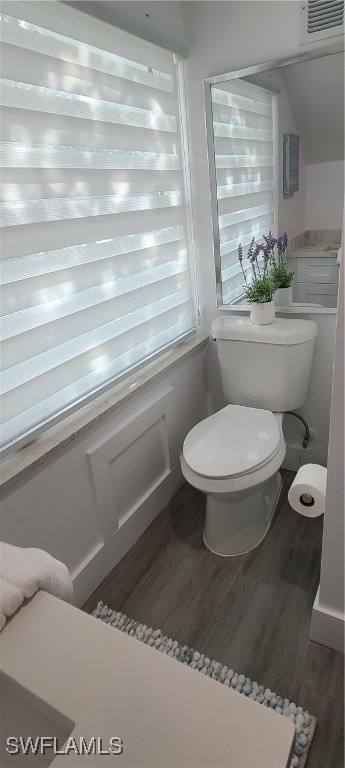 bathroom with hardwood / wood-style floors and toilet