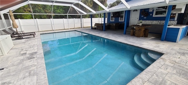 view of pool with a patio and a lanai