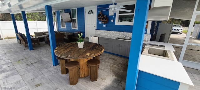 view of patio / terrace with ceiling fan and sink