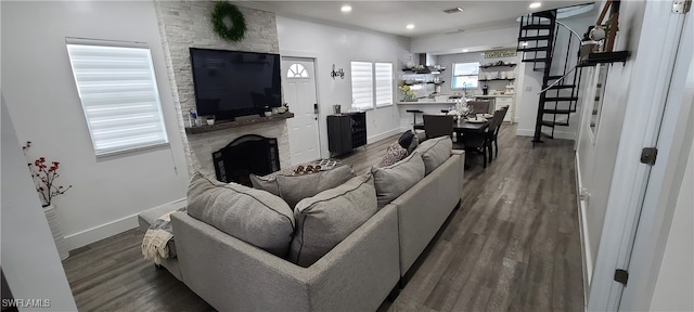 living room with dark wood-type flooring and a fireplace