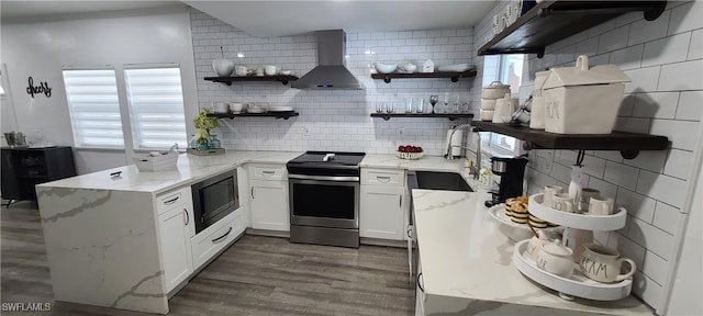 kitchen featuring wall chimney range hood, white cabinetry, dark hardwood / wood-style floors, built in microwave, and electric stove