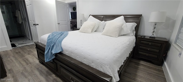 bedroom with dark wood-type flooring