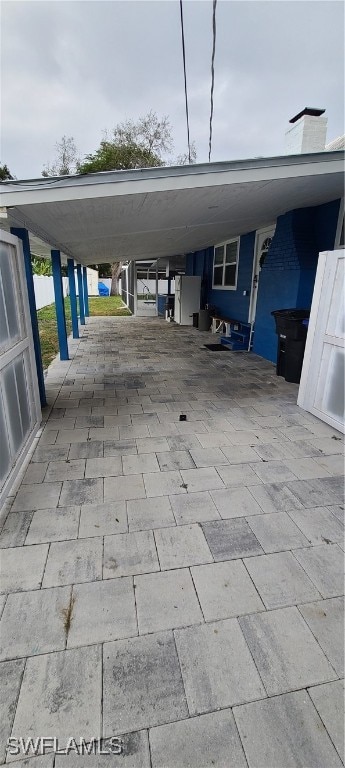 view of vehicle parking featuring a carport