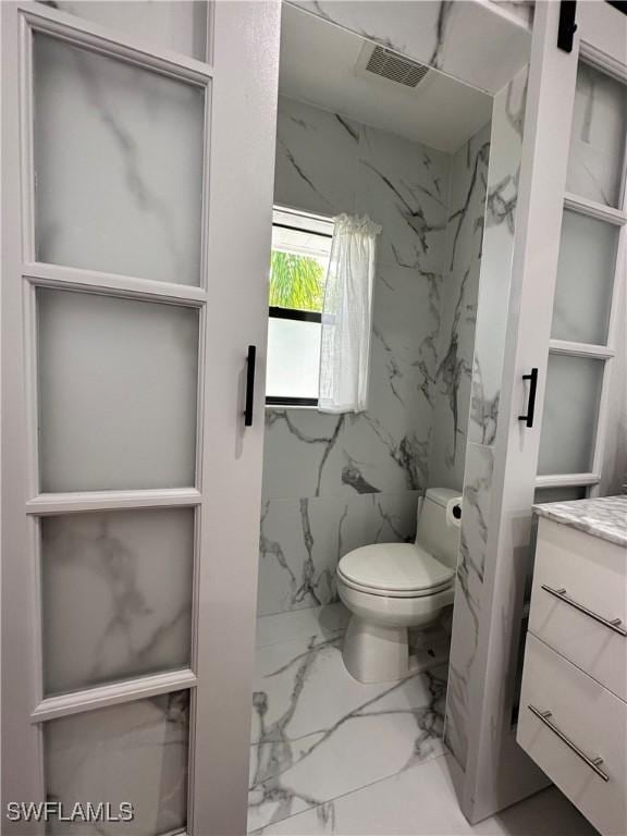 bathroom featuring toilet and vanity