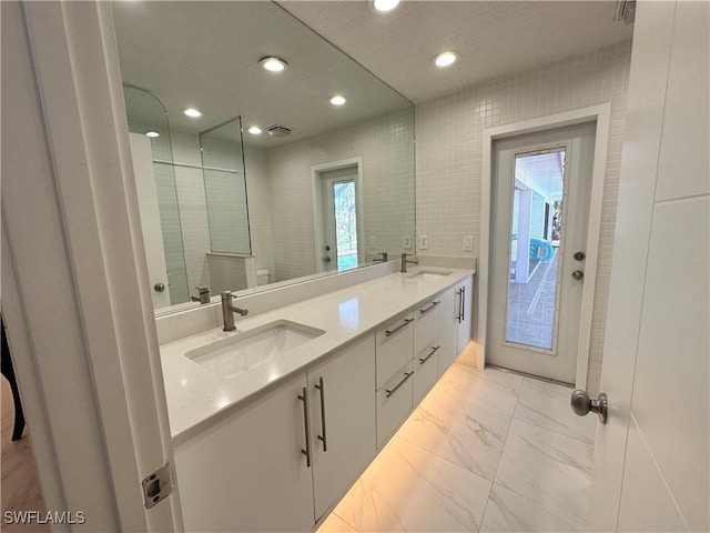 bathroom featuring tile walls and vanity