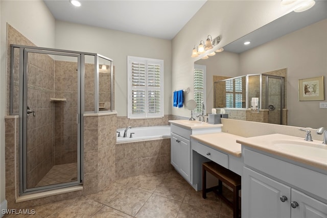 bathroom with tile patterned floors, vanity, and shower with separate bathtub