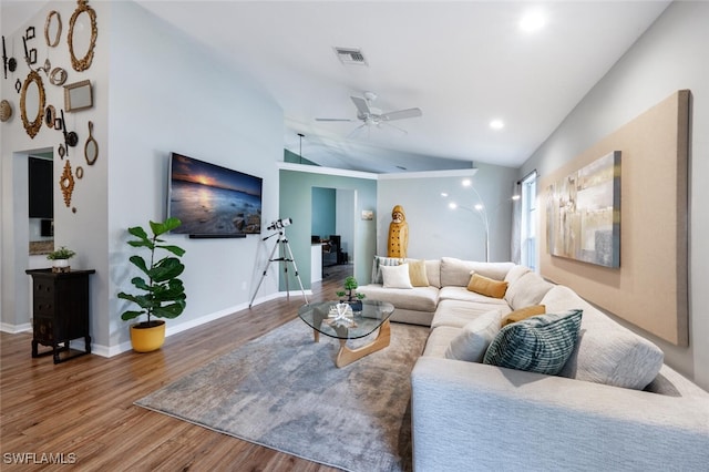 living room with wood-type flooring, lofted ceiling, and ceiling fan