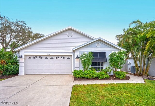 ranch-style home featuring a garage and a front lawn