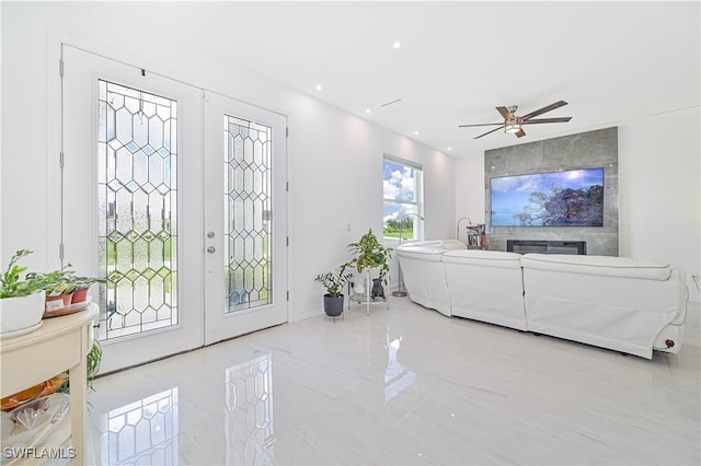 living room featuring ceiling fan and french doors