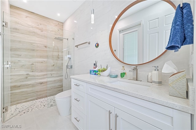 bathroom with vanity, toilet, an enclosed shower, and tile patterned floors