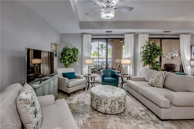 living room featuring wood-type flooring and ceiling fan