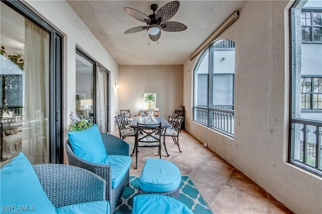 balcony with an outdoor hangout area and ceiling fan