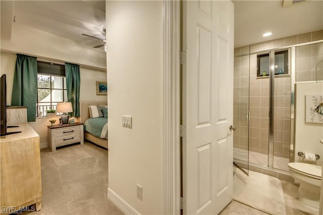 bathroom with walk in shower, toilet, and ceiling fan