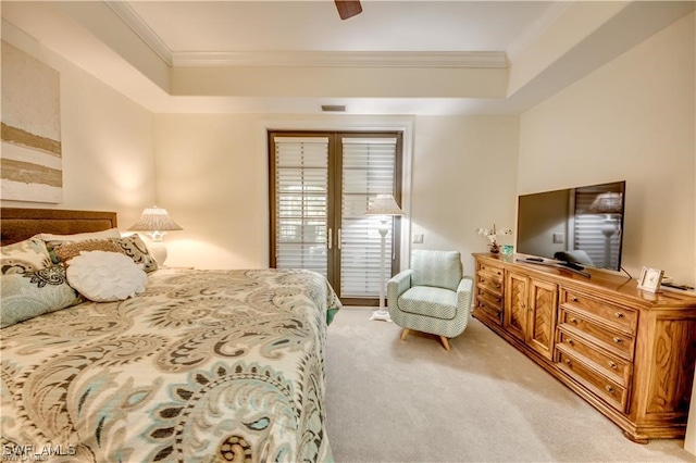 carpeted bedroom featuring ceiling fan, a tray ceiling, french doors, and ornamental molding