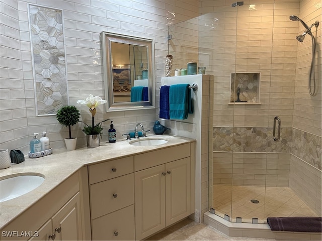 bathroom with vanity, a shower with shower door, decorative backsplash, and tile walls