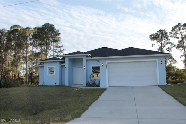 ranch-style home with a garage and a front lawn