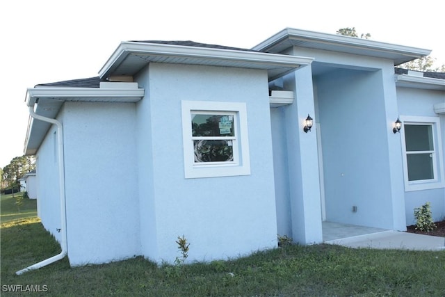 view of property exterior with a yard