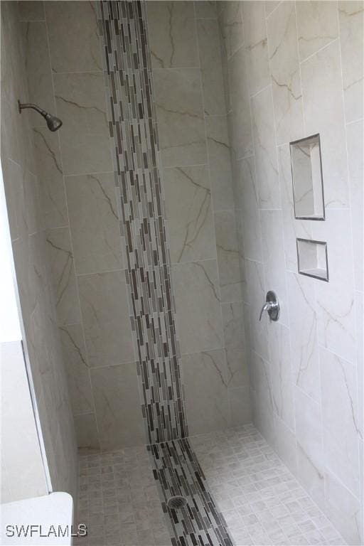 bathroom with tiled shower