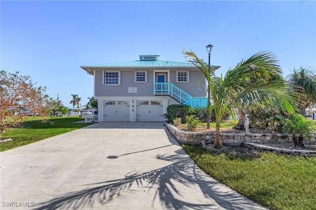 view of front of house with a garage and a front lawn