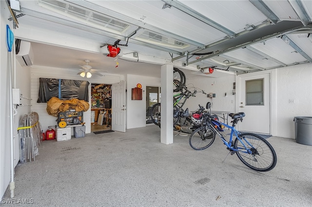 garage featuring a garage door opener, a wall mounted AC, and ceiling fan