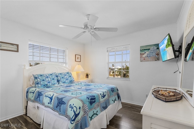 bedroom with ornamental molding, multiple windows, dark hardwood / wood-style floors, and ceiling fan