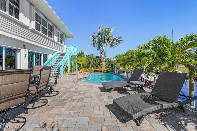 view of swimming pool with a patio