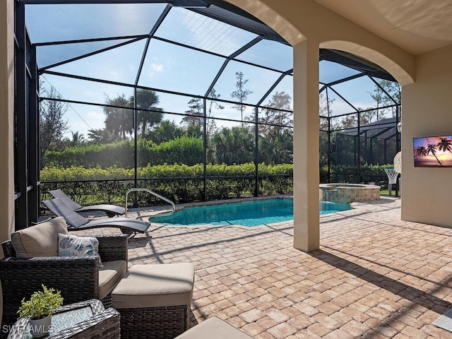 view of swimming pool with an in ground hot tub, a patio area, and a lanai