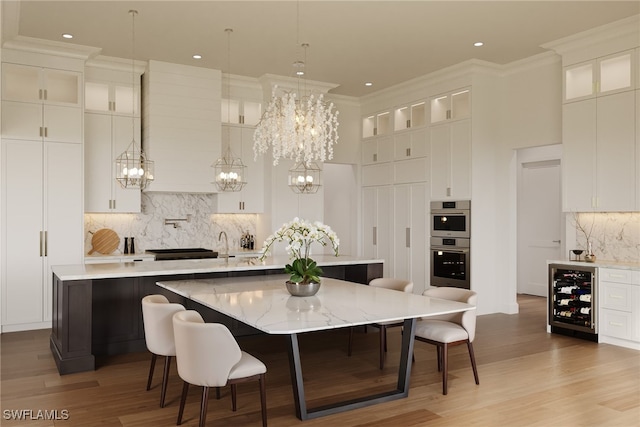 kitchen featuring a large island, light wood-type flooring, and a breakfast bar