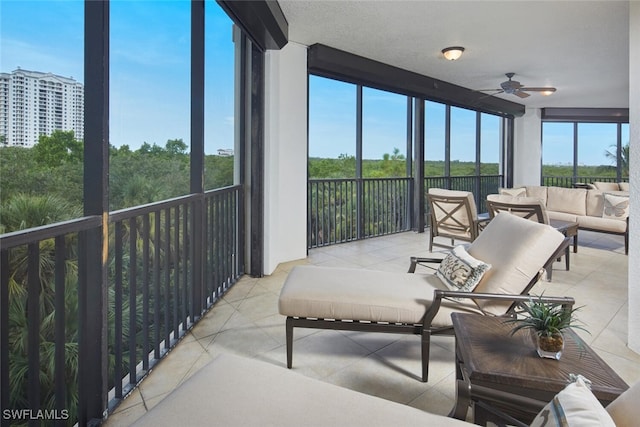 sunroom featuring ceiling fan