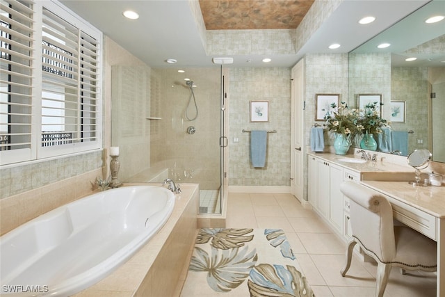 bathroom featuring tile patterned floors, vanity, independent shower and bath, and a raised ceiling