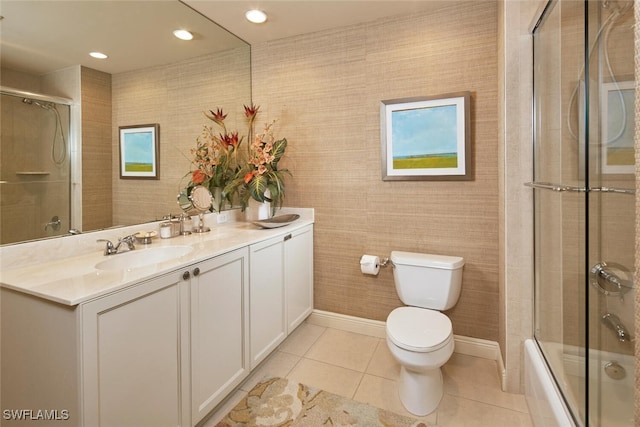 full bathroom featuring bath / shower combo with glass door, vanity, tile patterned flooring, and toilet