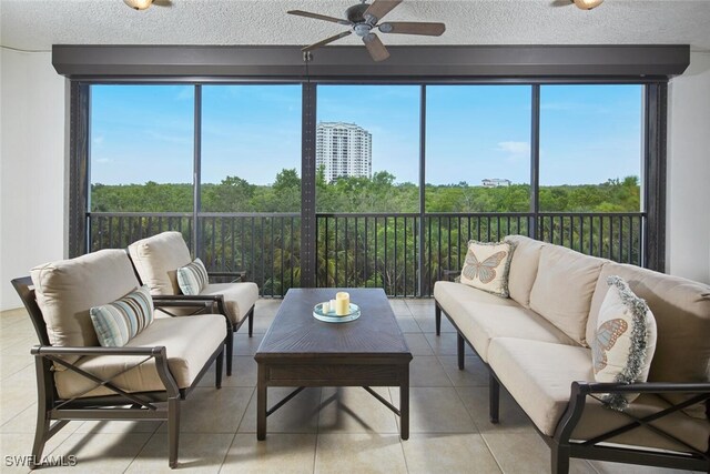 sunroom featuring a healthy amount of sunlight and ceiling fan