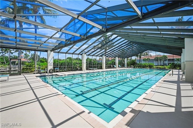 view of swimming pool with a lanai and a patio area