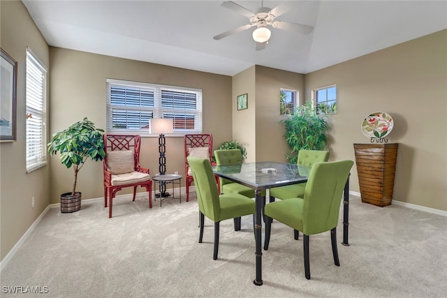 carpeted dining space featuring plenty of natural light and ceiling fan