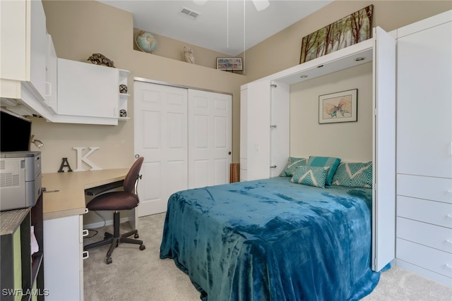 carpeted bedroom with ceiling fan and a closet