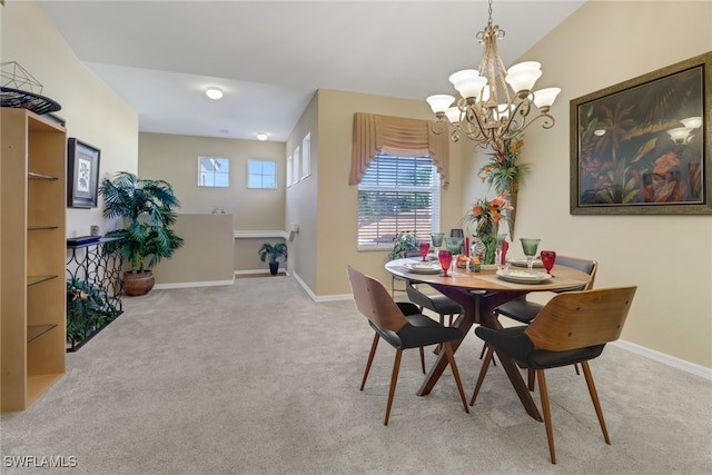 dining area with light carpet and a chandelier