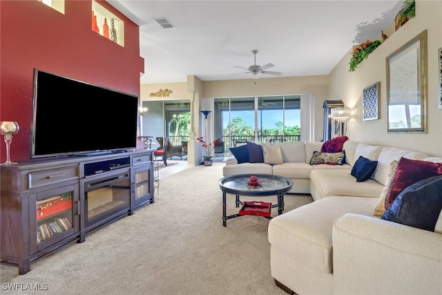 living room with light colored carpet and ceiling fan