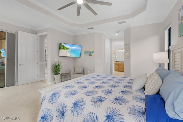 bedroom featuring ornamental molding, ensuite bathroom, light colored carpet, and ceiling fan