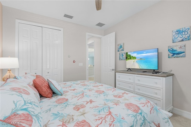 carpeted bedroom featuring a closet and ceiling fan