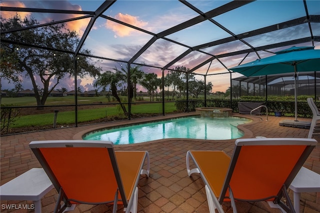 pool at dusk featuring an in ground hot tub, a patio, and glass enclosure