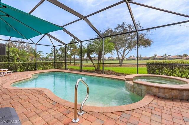 view of pool featuring a patio, an in ground hot tub, and a lanai